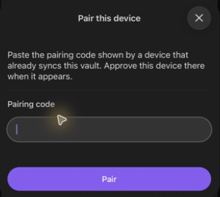 The phone's Pair this device dialog with an empty Pairing code field and Pair button