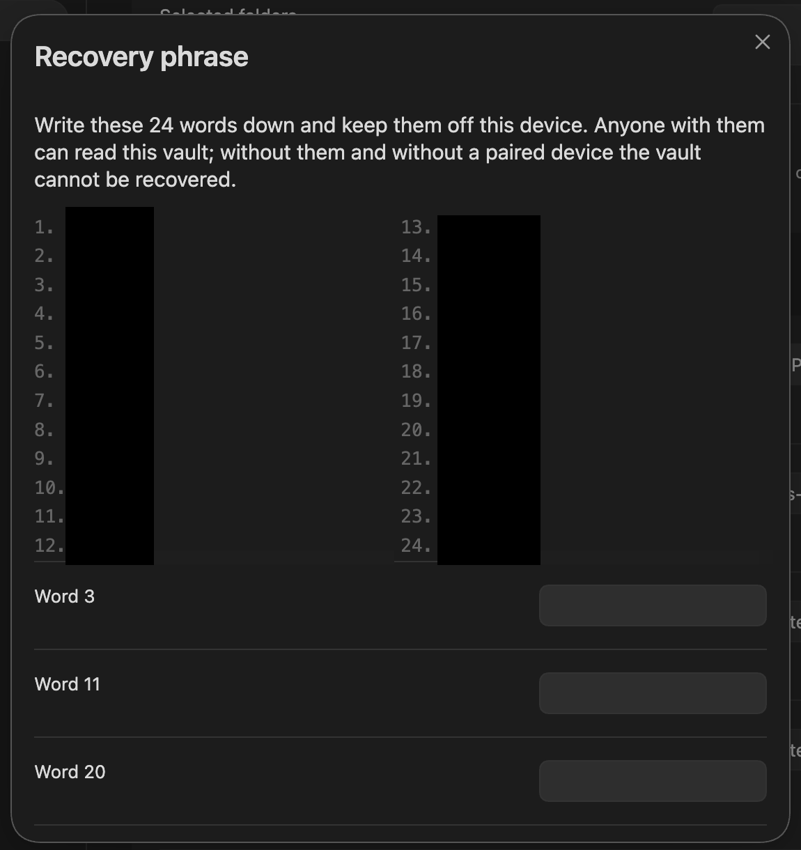 The recovery-phrase dialog shown after first-time setup, its words obscured